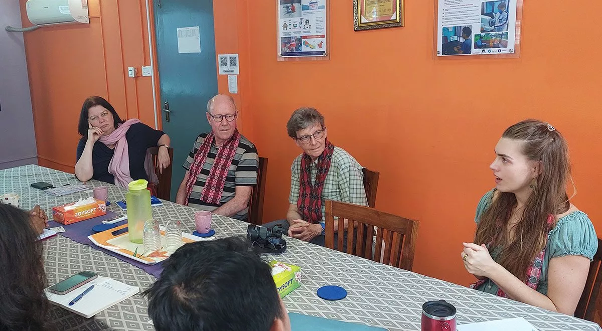 BNMT UK and BNMT Nepal colleagues meeting around a table